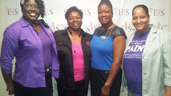 Members of PAIN, Inc. pose with Sybrina Fulton.