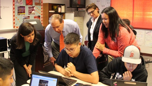 Federal Communications Commissioner Jessica Rosenworcel, from left, Sen. Tom Udall and Hatch Valley High School English teacher Audra Bluehouse look on as students play a vocabulary word game in Bluehouse’s class. Behind them is Angela Navarette, vice president-general manager of Univision’s KBNA, KANA and KQBU stations in El Paso. Many students at Hatch Valley High School have access to computers and the internet only at school.