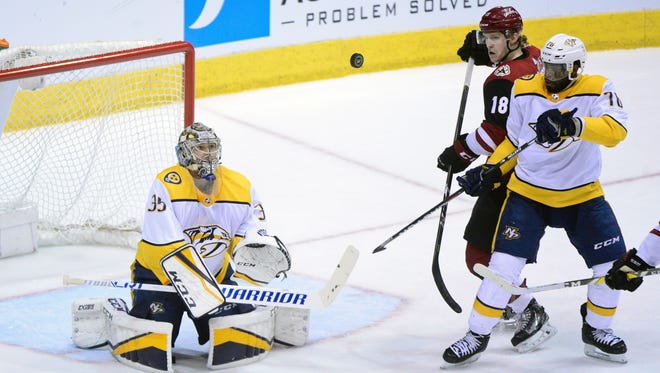 Predators goalie Pekka Rinne (35), defenseman P.K. Subban (76) and Coyotes left wing Christian Dvorak (18) watch as a deflected puck floats during the second period Thursday.