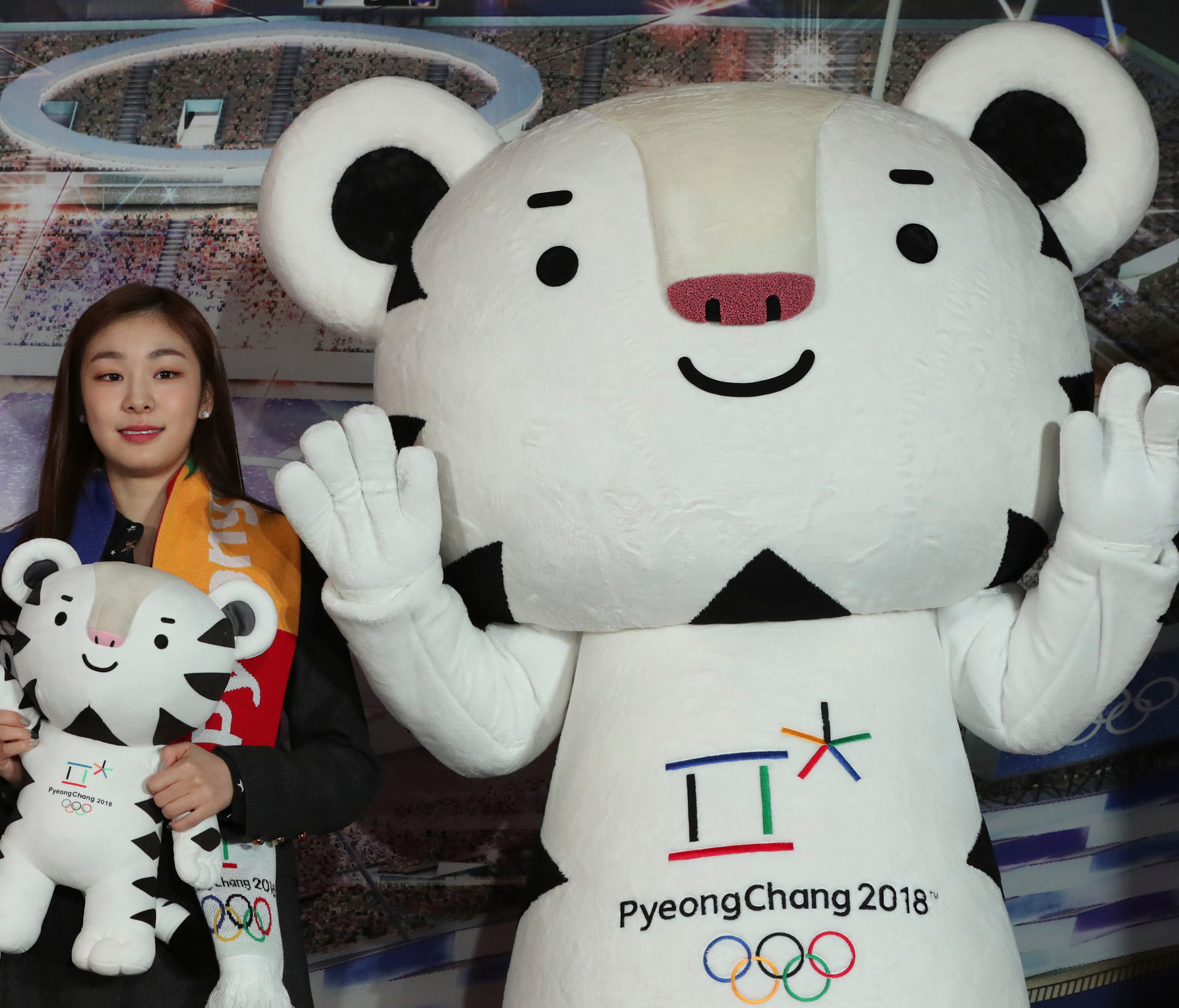 Figure skating Olympics gold medalist Yuna Kim, an honorary ambassador for the 2018 Winter Olympics, poses with an official mascot of the 2018 Pyeongchang Olympic Winter Games, white tiger 