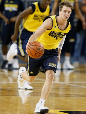 Michigan's Spike Albrecht brings the ball up court during a basketball practice.