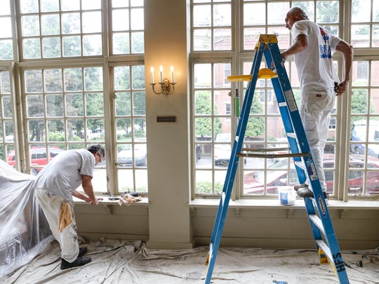 Painters work on the window trim inside the current Filson Historical Society space that is undergoing updates and renovation work.