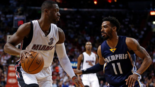 Dwyane Wade is pressured by Mike Conley during the second half at American Airlines Arena.