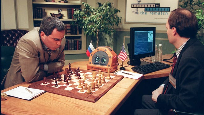 Garry Kasparov, left, is contemplating his next move against Deep Blue, IBM's chess playing computer Sunday, May 4, 1997, in New York.
