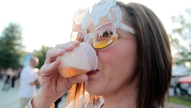 Pam Deshotel takes a sip of one of her beer samples while sporting a pair of "beer goggles" during Gulf Brew, a beer-tasting event benefiting the Acadiana Center for the Arts, in 2014, at Parc International in downtown Lafayette.