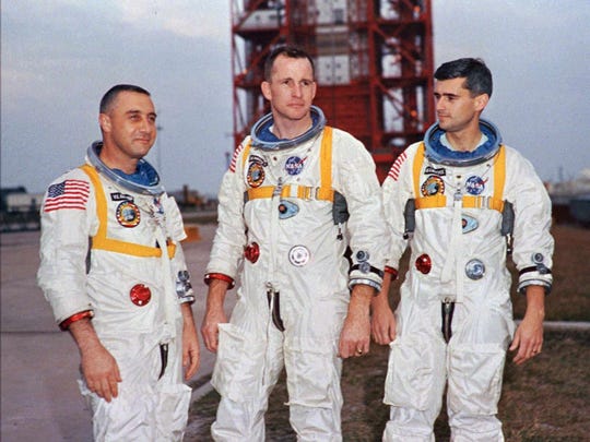 Apollo 1 astronauts, from left, Virgil "Gus" Grissom, Edward White II, and Roger Chaffee pose next to their Saturn 1 launch vehicle in this Jan. 17, 1967, photo at Launch Complex 34 at Cape Canaveral Air Station in Cape Canaveral, Fla.