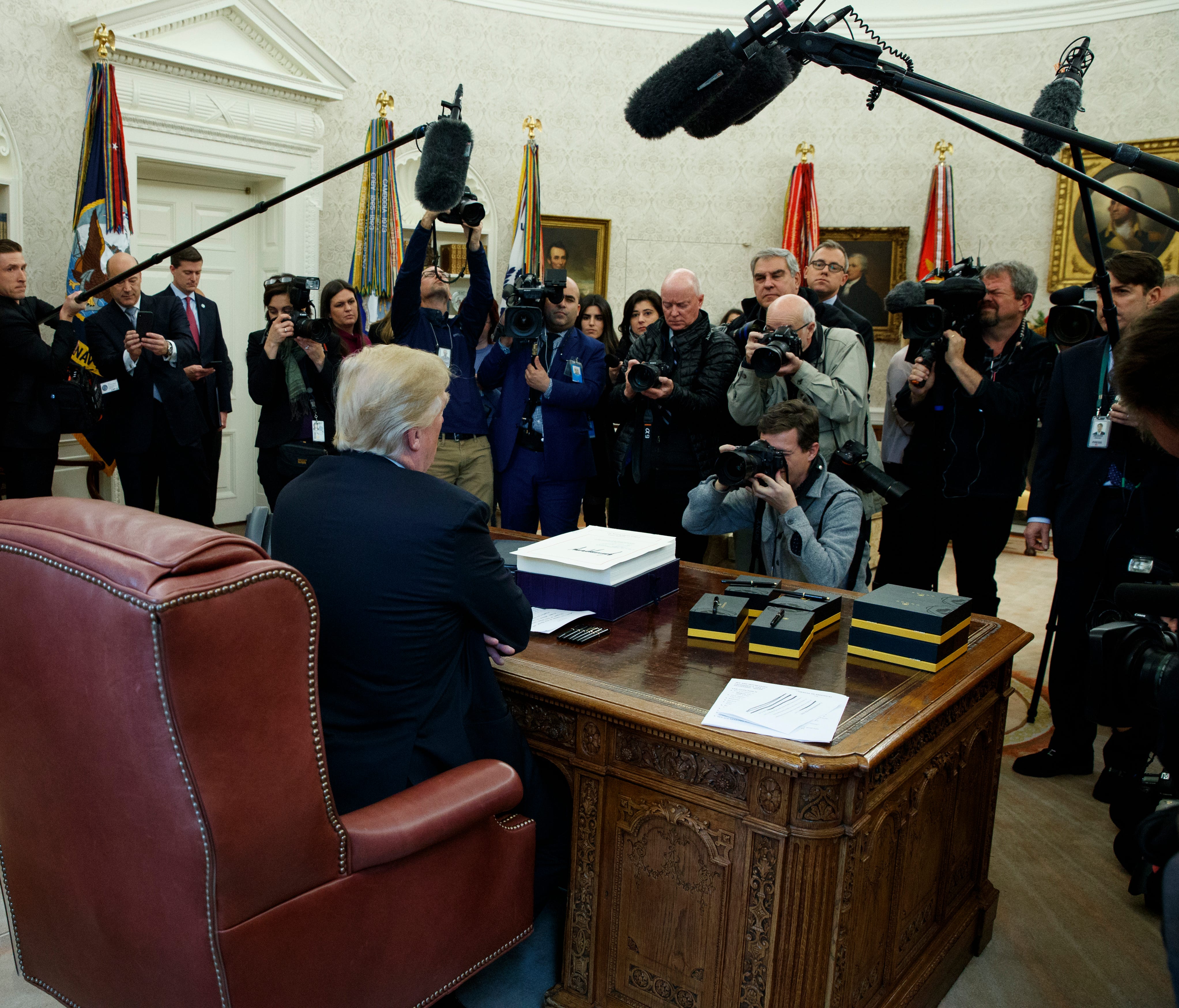 President Trump speaks to reporters in the Oval Office after signing the tax bill and continuing resolution to fund the government Dec. 22, 2017.