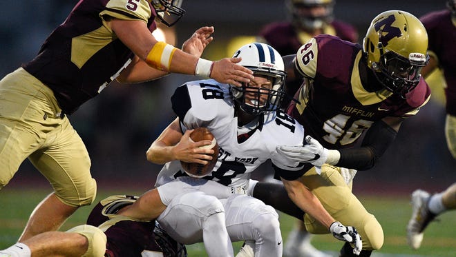 West York's Corey Wise is swarmed by three Governor Mifflin defenders during a 2017 game. Governor Mifflin is one of 13 Berks County schools slated to become associate football members of the Lancaster-Lebanon League in 2022.