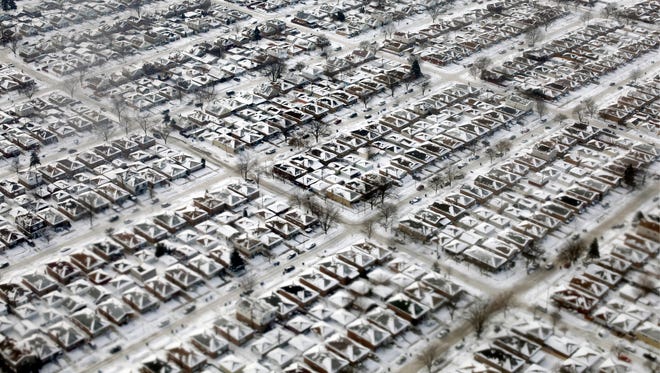 In this  Jan. 8, 2014,  file photo, homes are covered in snow and ice in Chicago.