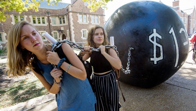 Students pull a mock "ball & chain" representing the $1.4 trillion outstanding student debt at Washington University in St. Louis.