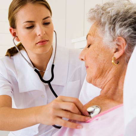 Stock image -- Nurse checking woman's heartbeat.   For this story" Top retirement financial concern: Health care bills [Via MerlinFTP Drop]