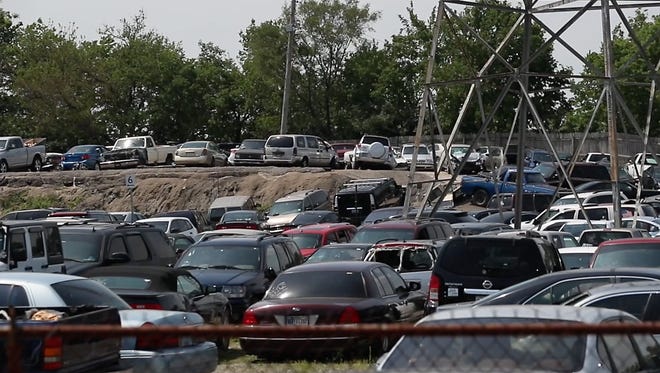 Louisville's 13-acre police impoundment lot is currently above capacity.