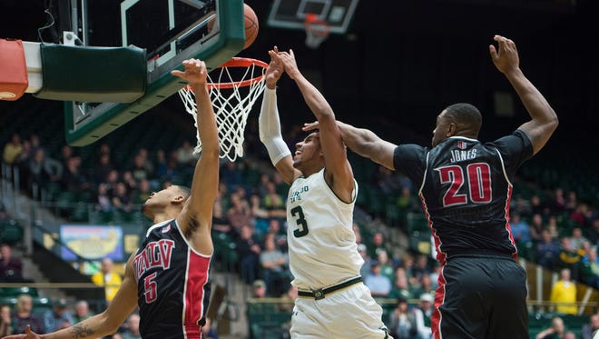 CSU's Gian Clavell goes between UNLV defenders Jalen Poyser (5) and Christian Jones to get to the rim during Wednesday night's game at Moby Arena. Clavell scored 21 points and pulled down 11 rebounds for the Rams in a 91-77 win.