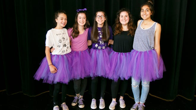 Straub Middle School students Cammie Alves, Megan Vaughn, Olivia Nell, Savannah Jones and Amani Noor pose for a photo in their purple tutus on Friday, June 3, 2016. Eighth grader Olivia Nell has epilepsy and is organizing a walk to raise awareness for the seizure disorder; her mother Lisa Nell made the tutus to celebrate epilepsy awareness.