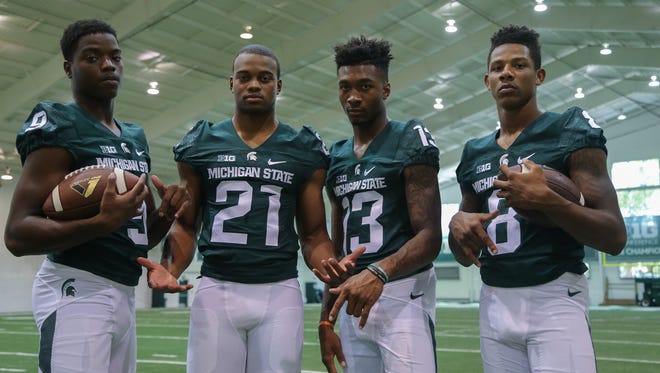 Donnie Corley, left, knows he will play in MSU's opener Friday against Furman. His fellow true freshmen receivers Cam Chambers (21), Justin Layne (13) and Trishton Jackson are waiting for coaches to decide if one or any of them will play this season.