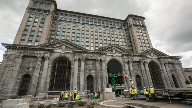 Workers set up for the upcoming train station party at Michigan Central Station in Detroit's Corktown neighborhood on Wednesday, June 13, 2018 to celebrate Ford Motor Company's purchase of the long-vacant building. 