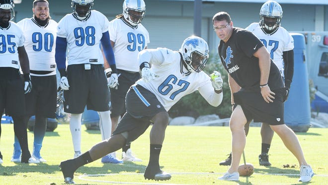 Defensive tackle Louis Palmer runs the rings, chasing tennis balls, during defensive line drills Monday.