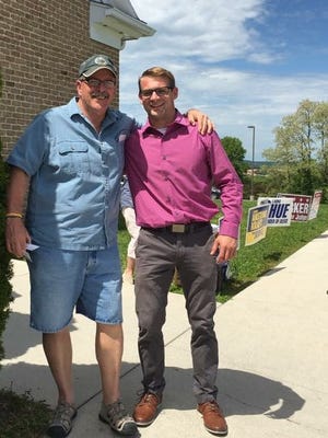 Clint Wright, standing right, poses with friend Wallace Rodenhaber outside of a polling place during the May primary election. Wright won a seat on the South Western school board in a municipal election on Nov. 7.