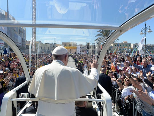 Pope Francis greets the crowd to celebrate a mass in