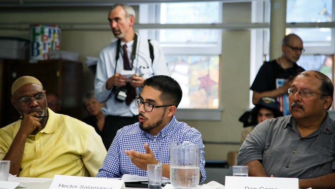 Hector Salamanca, center, talks to Democratic presidential candidate Martin O'Malley during one of his campaign stop at Trinity United Methodist Church in Des Moines.