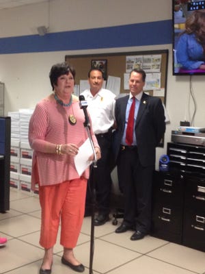 Major Anita Flagg announces Brandy Sweeney as the Dispatcher of the Year for the Murfreesboro Police and Fire and Rescue Communications Center while Fire Chief Mark Foulks and Police Chief Karl Durr, right, look on.