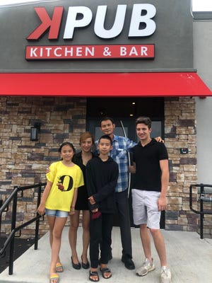 Richie Mauro, right, is the recipient of the 2020 Saugus High School Edna Winslow Alumni Hockey Scholarship (sponsored by K Pub). Kevin Ye, the owner of K Pub, is pictured with his family. Courtesy photo