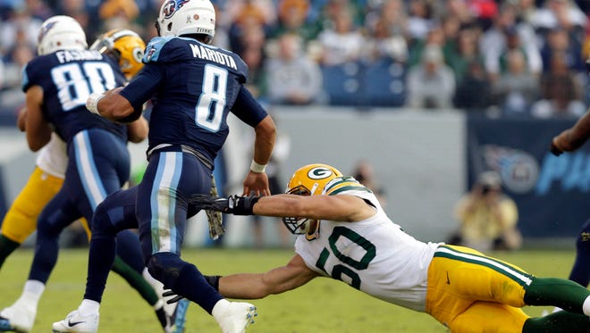 Tennessee Titans quarterback Marcus Mariota (8) eludes Green Bay Packers inside linebacker Blake Martinez (50) during the Green Bay Packers 47-25 loss to the Tennessee Titans during the NFL football game at Nissan Stadium in Nashville, Tennessee,Sunday, November 13, 2016.
