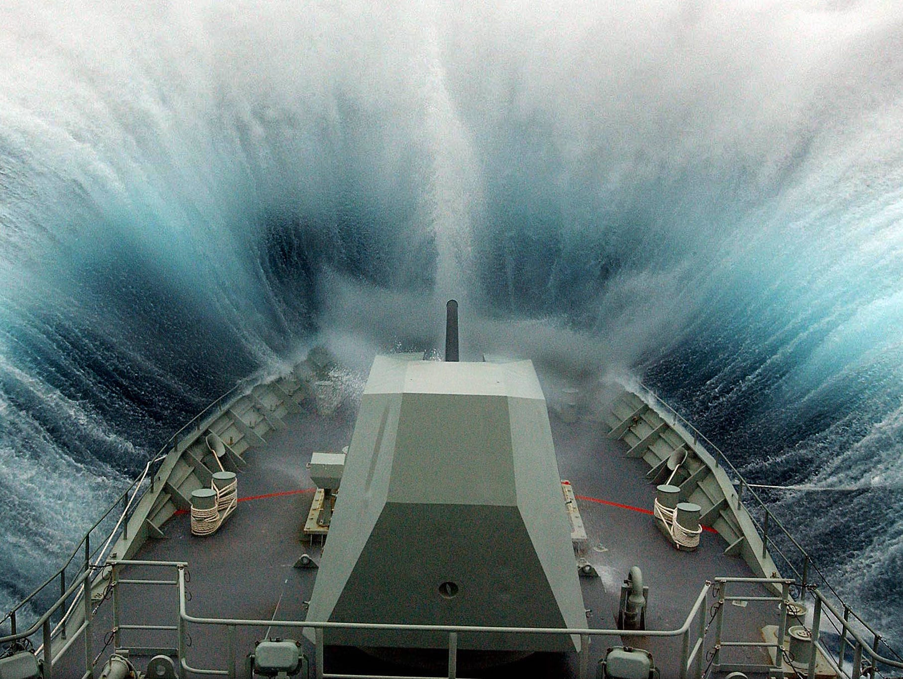An Australian frigate, the HMAS Warragunga, crashes through the waves in the remote Southern Ocean as it pursues a Uruguayan-flagged trawler suspected of illegal fishing in 2004.