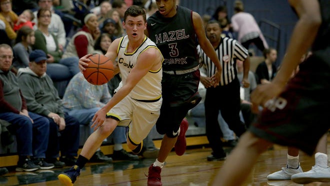 Clarkston's Foster Loyer (1), dribbles past Hazel Park's David Hearns (3) during a game on Thursday, Jan. 12, 2017 at Clarkston High School.