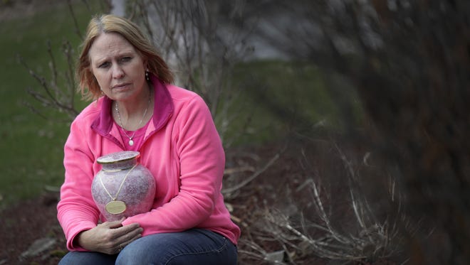 Bev Kelly-Miller holds the urn of her daughter Megan Kelly on April 14, 2017, at her home in Kaukauna. Megan, at the age of 22, died from a heroin overdose April 14, 2015.