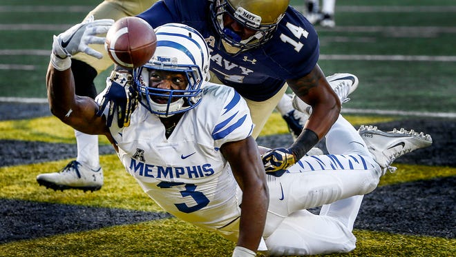 University of Memphis receiver Anthony Miller (bottom) can not hang onto a touchdown reception while defended by Navy cornerback Elijah Merchant (top) during second quarter action at Navy-Marine Corps Memorial Stadium in Annapolis, Maryland.