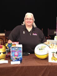 Michele Michaels, posed with noisy toys, is a hard-of-hearing