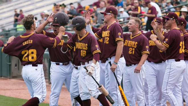 The Arizona State Sun Devils cheer for teammate David Greer after his home run at the start of the series finale game against Texas Christian University at the Phoenix Municipal Stadium in Phoenix, Sunday Feb. 22, 2015.