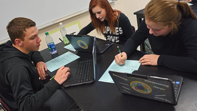 Roosevelt High School freshman from left, William Rolfe, 14, Chloe Moncor, 15, and Brianna Steffes, 15, work on a worksheet during a biology class Thursday, Jan. 26, 2017, at Roosevelt High School in Sioux Falls.