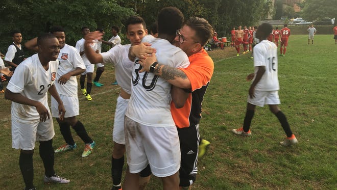 Spring Valley boys soccer head coach Ryan Marcus hugs Alexander Taylor after scoring the game-winning goal in a 1-0 double-overtime win over North Rockland. Sept. 20, 2016.