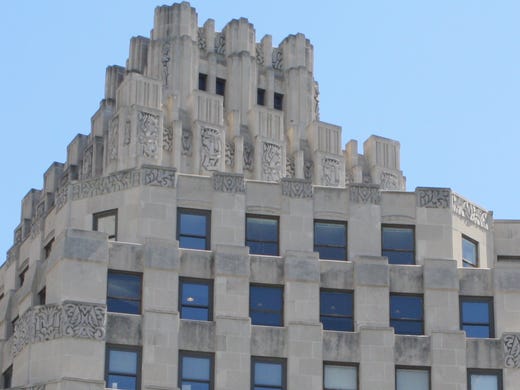 Its Art Deco Details. "Lavishly ornamented" are the words that come to mind when you visit the former Coca-Cola Bottling Company plant in the 800 block of Massachusetts Avenue in Indianapolis, built between 1931 and 1941 for the Indianapolis branch of the soft drink giant. At regular intervals along the creamy terra cotta facade are panels with crisply detailed flowers, flowing fountains, sun rays and organic foliage. All were inspired by the 1925 international Exposition des Arts Decoratifs in Paris, which stimulated a new architectural fashion worldwide, know as Art Deco. Another Indianapolis example of Art Deco is the 1929-30 Circle Tower (shown here) on Monument Circle, known for its stylized Egyptian figures and receding upper stories resembling a Sumerian ziggurat.