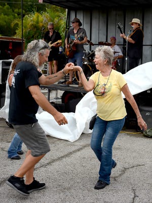 Organizer Mike Denisen dances with a friend to the music of Jimmy Whitaker. Area bikers got together at Gator's Crossroads on Sunday, Sept. 11, 2016, to collect donations for the victims of flooding in Louisiana.
