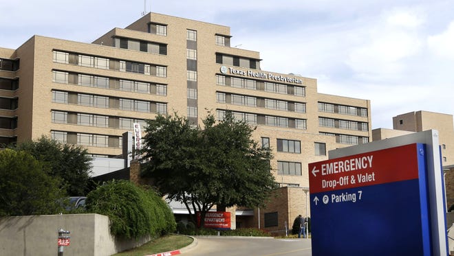 FILE - A sign points to the entrance to the emergency room at Texas Health Presbyterian Hospital Dallas, where U.S. Ebola patient Thomas Eric Duncan was being treated, in this Oct. 8, 2014 file photo, in Dallas. Health officials said Sunday Oct. 12, 2014 a health care worker at Texas Health Presbyterian Hospital who provided care for Eric Duncan has tested positive for Ebola in a preliminary test "confirmatory testing will be conducted by the Centers for Disease Control and Prevention in Atlanta." (AP Photo/LM Otero, File)