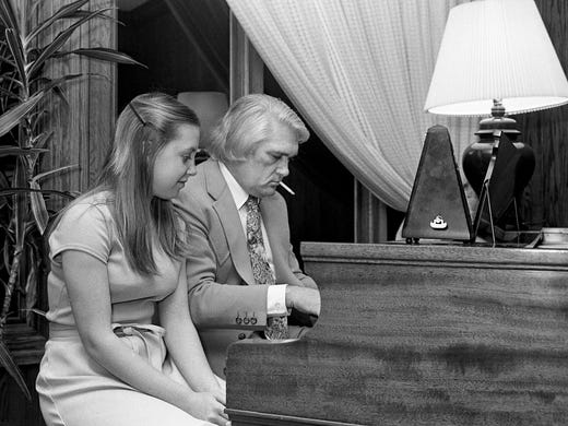 Charlie Rich, right, plays the piano as Catherine Sherrill
