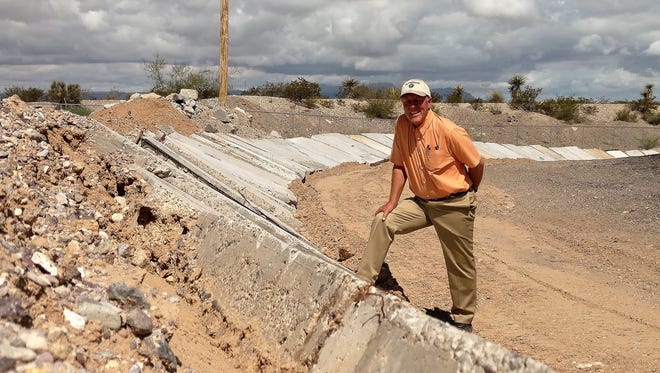 Wastewater Administrator Klaus Kemmer for Las Cruces stands on one of the 49 concrete slabs that have been positioned for flood water control at the Old Foothills Landfill.