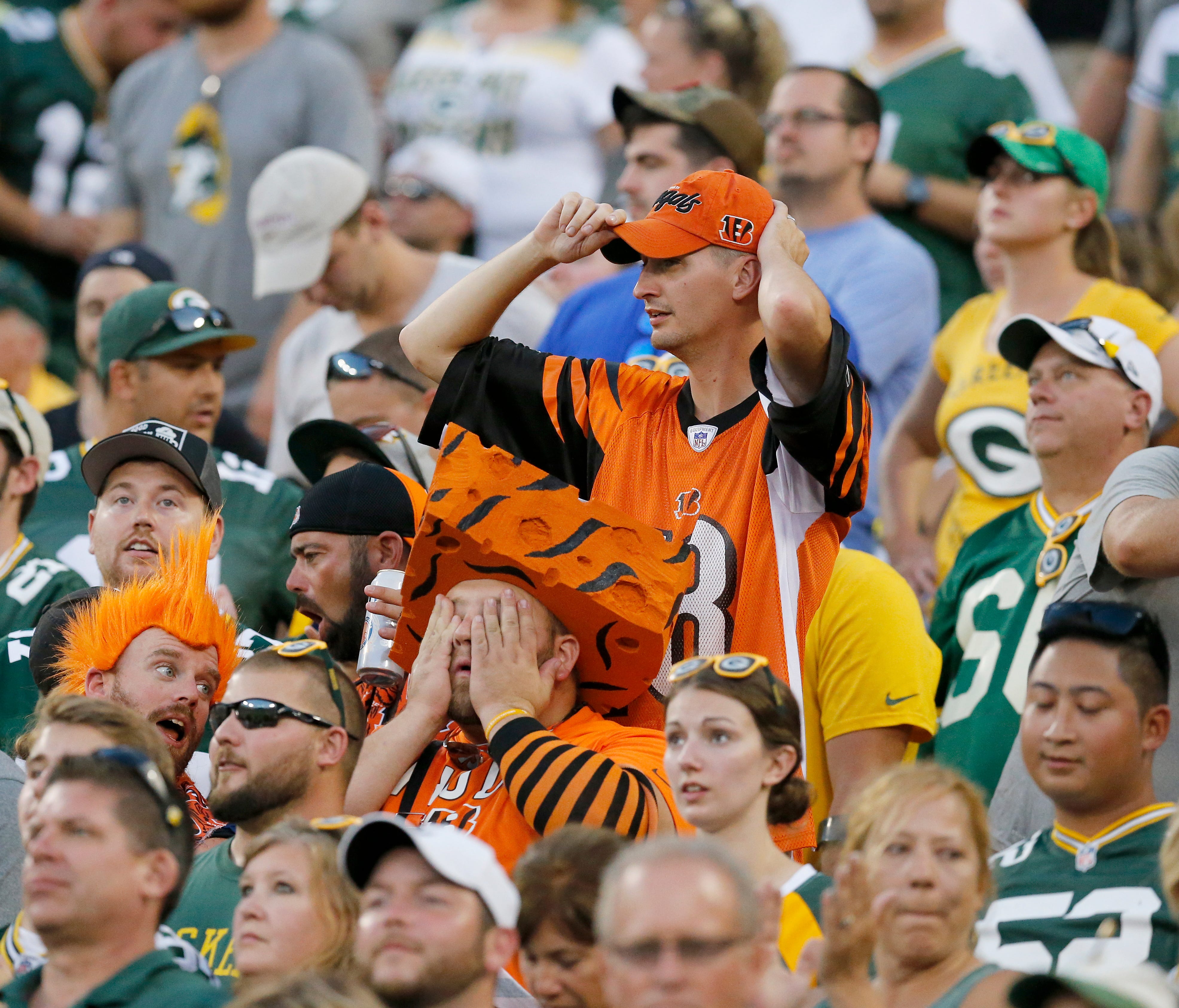 A pair of Bengals fans react as the Bengals fail to score on their possession in overtime of the NFL Week 3 game between the Green Bay Packers and the Cincinnati Bengals at Lambeau Field in Green Bay on Sunday, Sept. 24, 2017. The Bengals were droppe