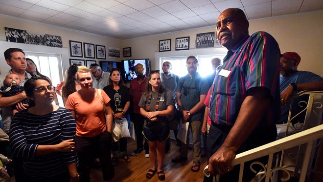 The Rev. Andrew Penns leads a tour of the Curtis House Cultural Center Tuesday. The group was a collection of international students attending a seminar at Hardin-Simmons University.