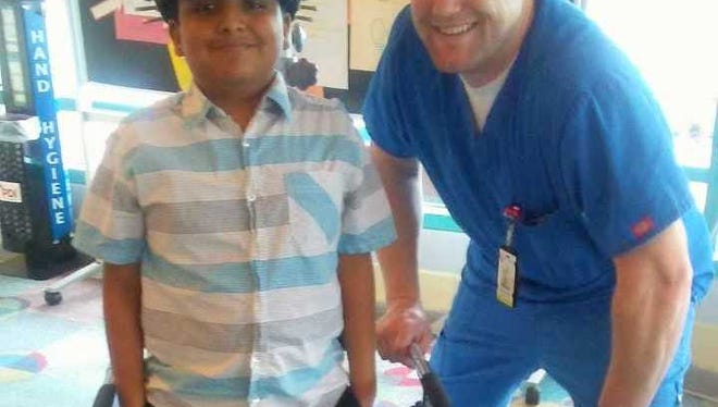 Daniel Villareal gets around the Shriner's Children's Hospital with the help of a walker and a halo. His nurse Walter is a great friend.