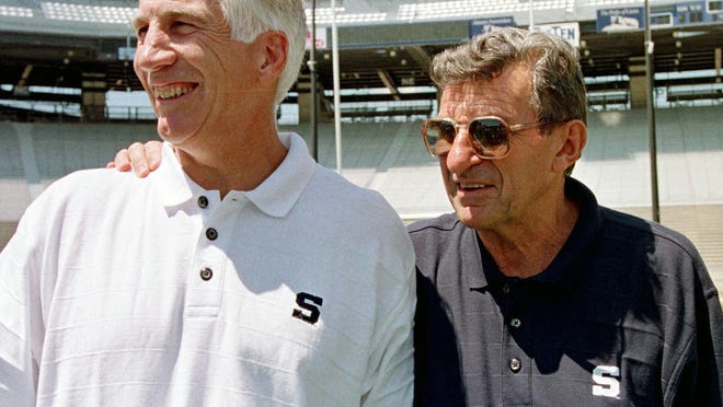 FILE - In this Aug. 6, 1999, file photo, Penn State football coach Joe Paterno, right, poses with his defensive coordinator Jerry Sandusky, during the college football team's media day in State College, Pa. Alumni-elected Penn State trustees who successfully fought for access to records about a university-commissioned report into how complaints about Sandusky were handled describe it as unreliable and misleading, adding fuel to a debate over the scandal that has roiled for more than seven years. (AP Photo/Paul Vathis, File)