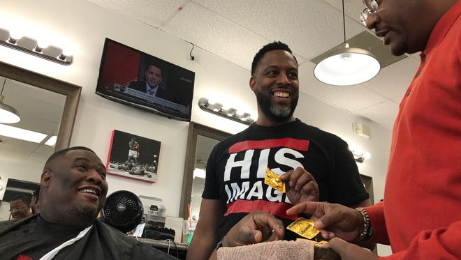 Ivan Thomas, Derrick Reed and Frank Hawkins talk about the role condoms have in preventing the transmission of HIV at Reed's Wilmington barbershop, His Image. 
Hawkins, of AIDS Delaware, works with barbershops and beauty salons to help inform their clients about HIV and STDs.