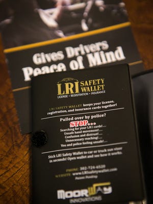 The LRI Safety Wallet is a tri-fold sleeve that holds a driver's license, insurance and vehicle registration and attaches to a car's visor to help drivers avoid reaching into their pocket or glove compartment when stopped by police.