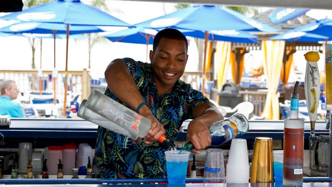 
Bartender Steven Gomes, who goes by Steve Anthony in his work, mixes a Turn-Up at the Bar Anticipation Beach Bar at the Trump Plaza in Atlantic City.
