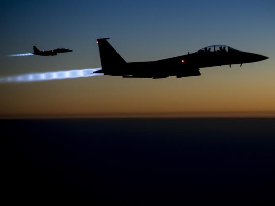 A pair of U.S. Air Force F-15E Strike Eagles fly over