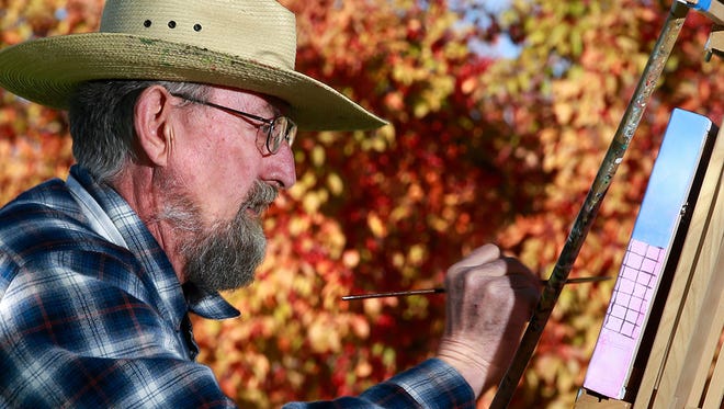Artist Tim Gordon of Aztec paints on the south lawn of the Farmington Public Library Oct. 22, 2016, during the Plein Air Celebrates Fall Colors event. The annual event returns to the library on Saturday.