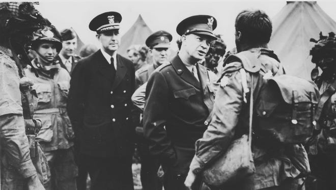 In this image provided by the U.S. Signal Corps, Supreme Commander Dwight Eisenhower visits paratroopers of the 101st Airborne Division at the Royal Air Force base in Greenham Common, England, three hours before the men board their planes to participate in the first assault wave of the invasion of the continent of Europe, June 5, 1944.